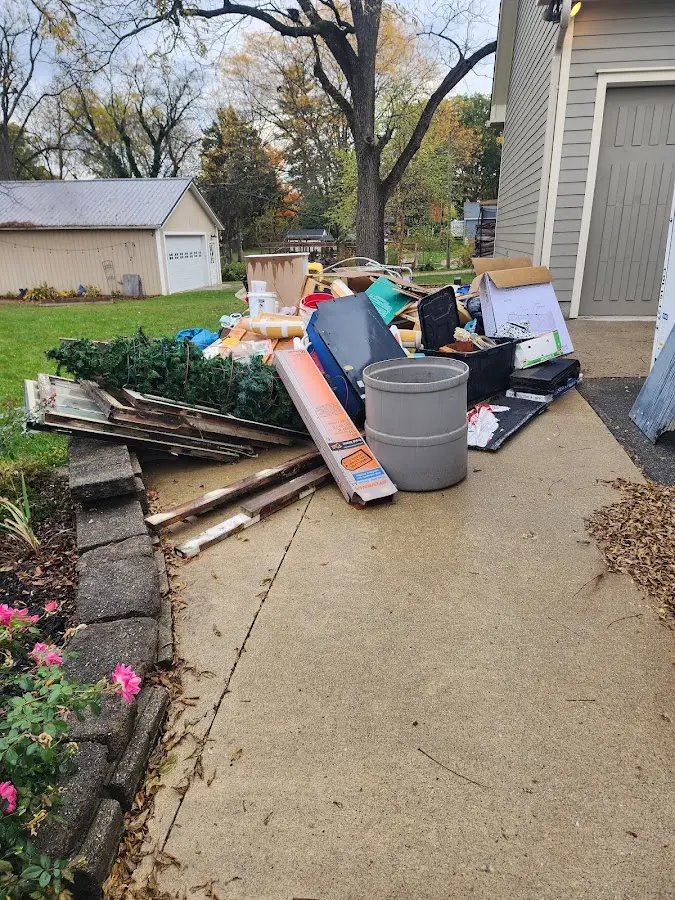 Dumpster being loaded with debris for 3 Yard Dumpster Rental in Normandy